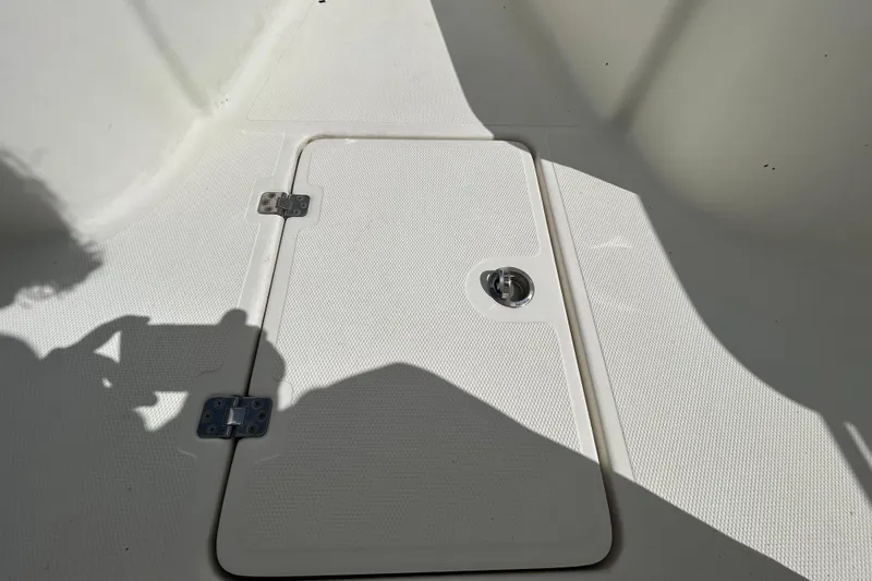 Slide: The Image of 2018 NauticStar 28 XS boat deck hatch with textured surface and metal latch. - 83