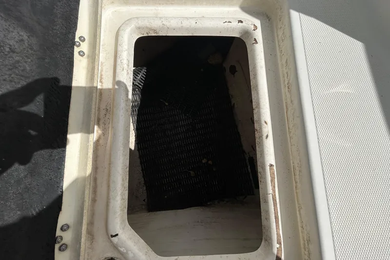 Slide: The Image of Open storage compartment on 2018 NauticStar 28 XS boat, showing interior details. - 85