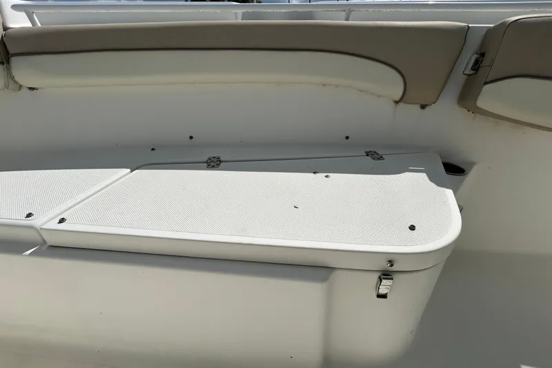 Slide: The Image of 2018 NauticStar 28 XS boat interior seating and storage compartment. - 86