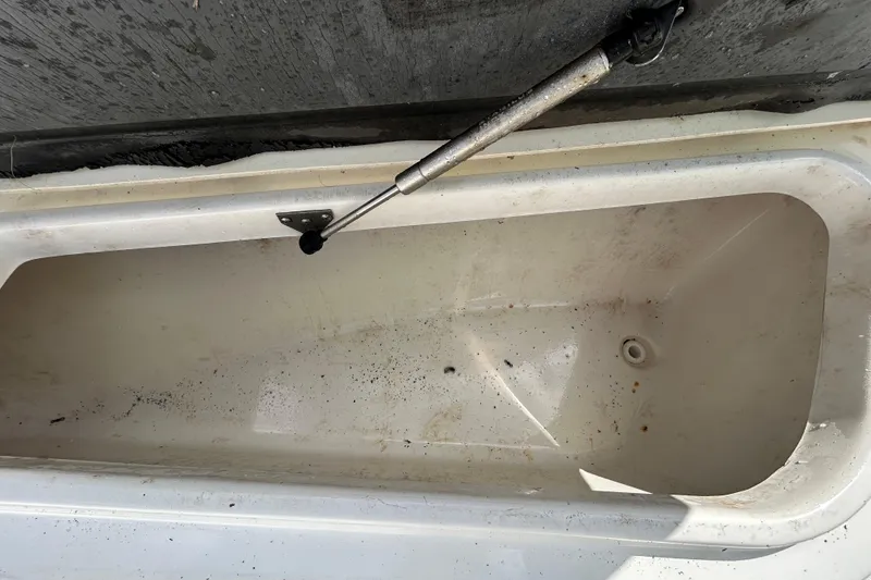 Slide: The Image of Open storage compartment on 2018 NauticStar 28 XS boat, showing interior details. - 88