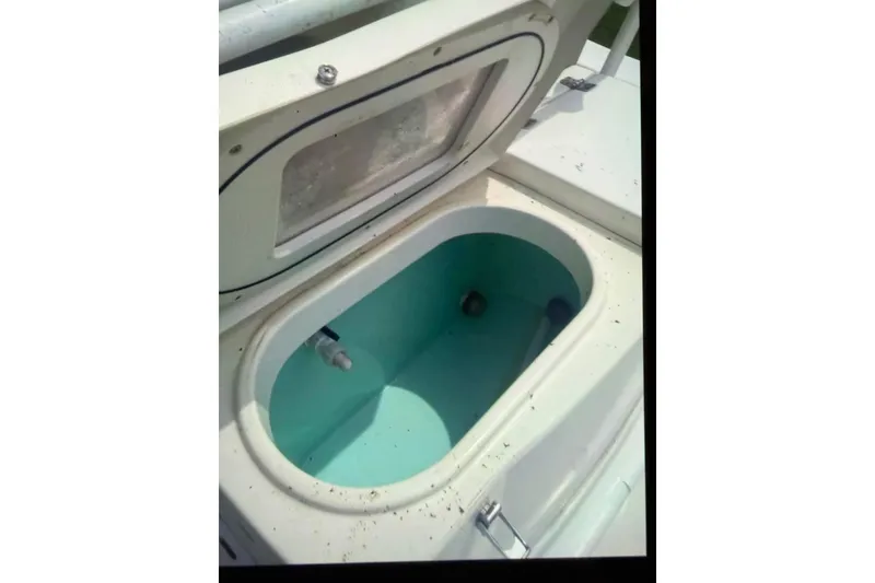 Slide: The Image of 2018 NauticStar 28 XS boat interior with seating, storage, and livewell. - 9