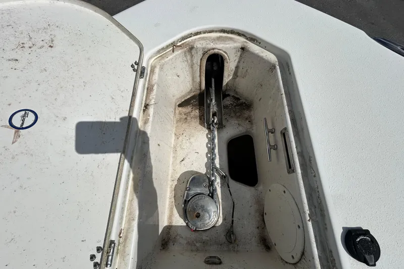 Slide: The Image of Anchor compartment of 2018 NauticStar 28 XS boat, showing chain and winch mechanism. - 91