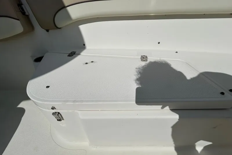 Slide: The Image of 2018 NauticStar 28 XS boat interior with seating and storage compartment. - 92