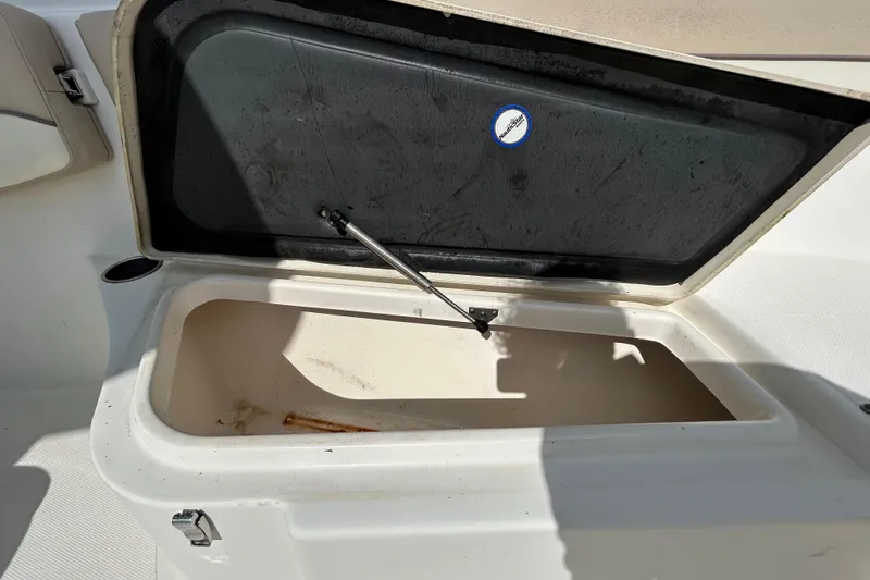 Slide: The Image of Open storage compartment on 2018 NauticStar 28 XS boat, showing interior details. - 93