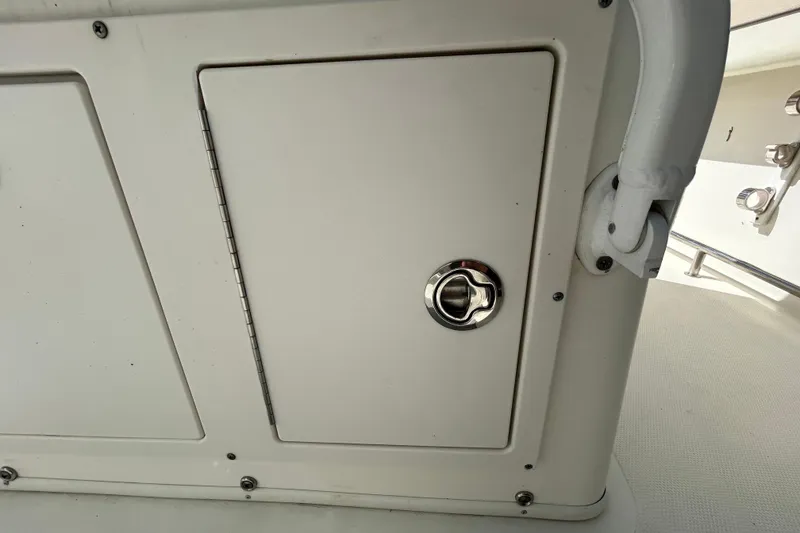 Slide: The Image of 2018 NauticStar 28 XS boat compartment with stainless steel latch. - 95