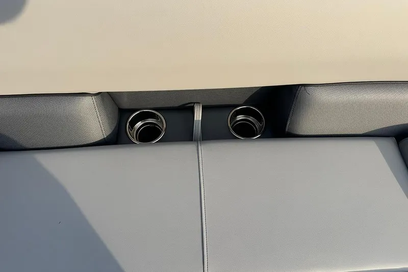 Slide: The Image of 2026 Bentley Pontoons Legacy 243 Swingback interior with dual cup holders and sleek seating. - 11
