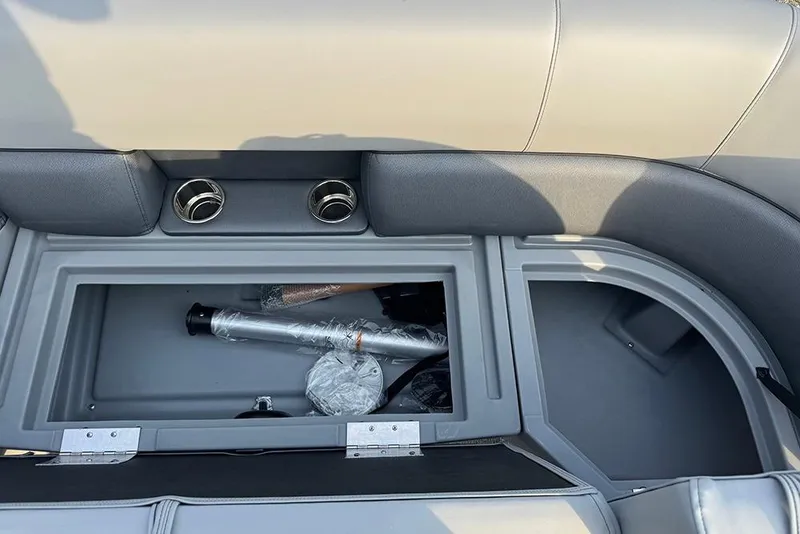 Slide: The Image of 2026 Bentley Pontoons Legacy 243 Swingback storage compartment with cup holders and accessories. - 12