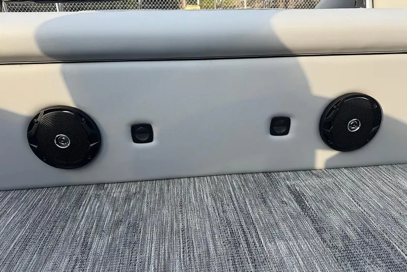 Slide: The Image of 2026 Bentley Pontoons Legacy 243 Swingback interior with speakers and modern upholstery. - 22