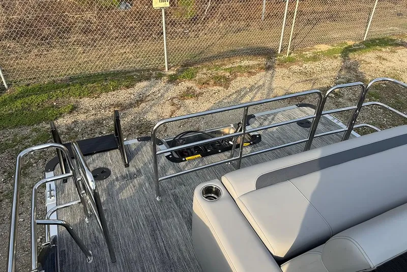Slide: The Image of 2026 Bentley Pontoons Legacy 243 Swingback interior with seating and railing, outdoor setting. - 28
