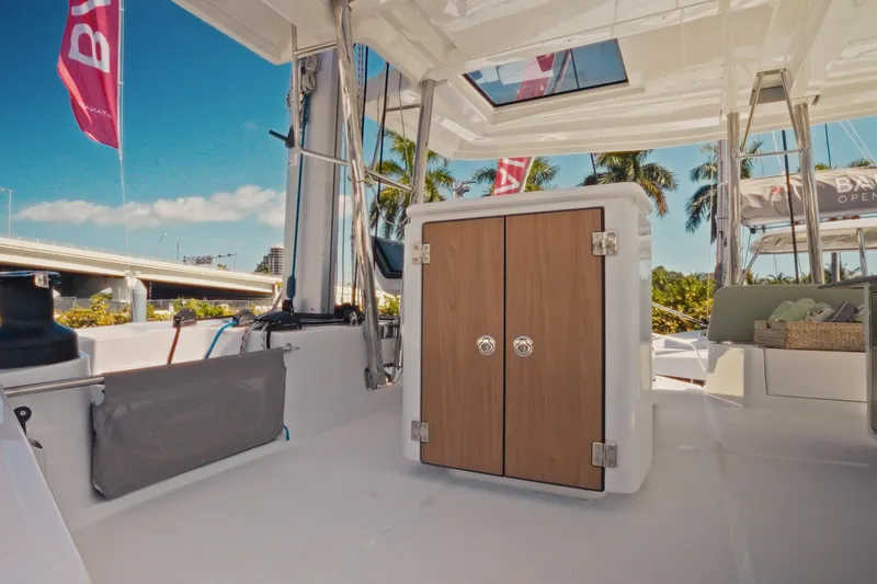 Slide: The Image of 2026 Bali 5.2 yacht interior with wooden cabinet, tropical setting, and clear blue sky. - 11
