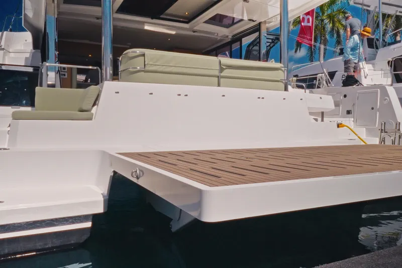 Slide: The Image of 2026 Bali 5.2 yacht with spacious deck and modern seating, docked under clear skies. - 12