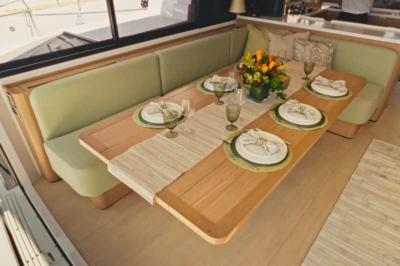 Slide: The Image of Elegant dining setup on 2026 Bali 5.2 yacht with floral centerpiece and green accents. - 13