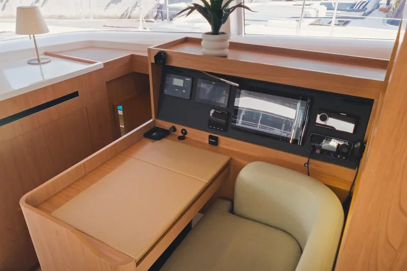 Slide: The Image of Modern navigation station on 2026 Bali 5.2 yacht with sleek wood finish and advanced controls. - 19