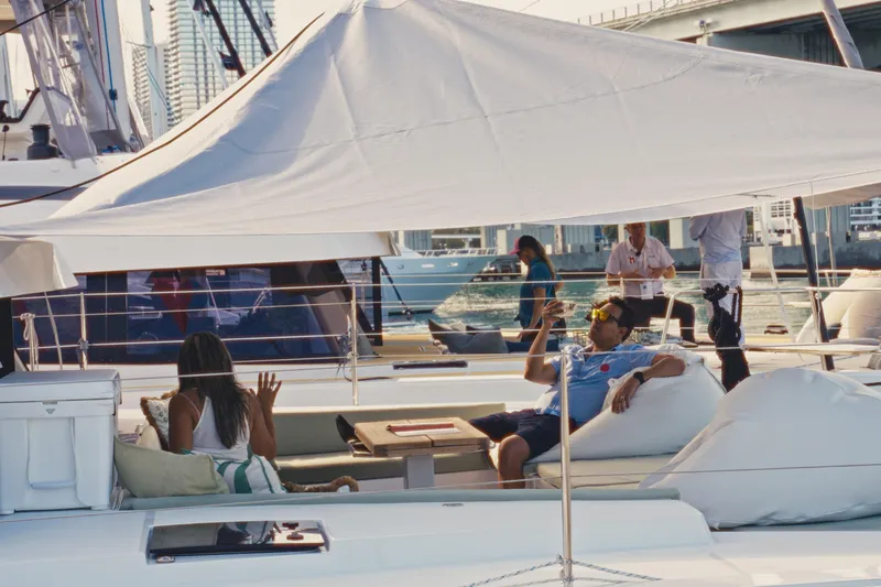 Slide: The Image of People relaxing on a 2026 Bali 5.2 yacht under a sunshade, enjoying a sunny day. - 2