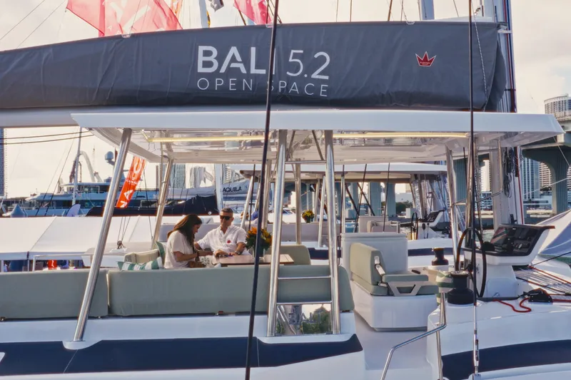 Slide: The Image of 2026 Bali 5.2 yacht with people relaxing on deck, showcasing open space design. - 3