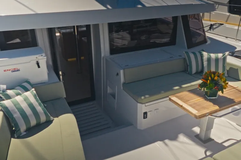 Slide: The Image of Luxurious Bali 5.2 yacht interior with striped cushions and wooden table, 2026 model. - 4