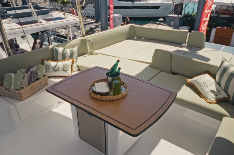 Slide: The Image of Luxurious seating area on 2026 Bali 5.2 yacht with elegant table and cushions. - 9