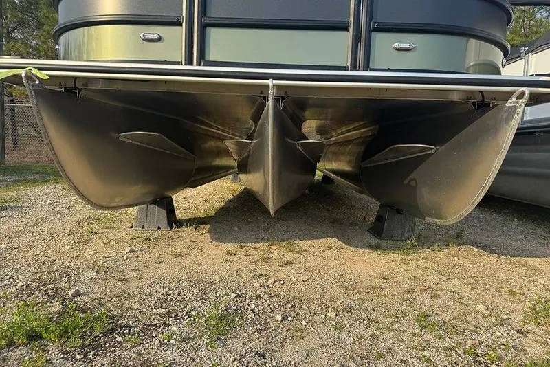 Slide: The Image of 2026 Bentley Pontoons Legacy 223 Swingback, close-up of pontoon hulls on gravel. - 10