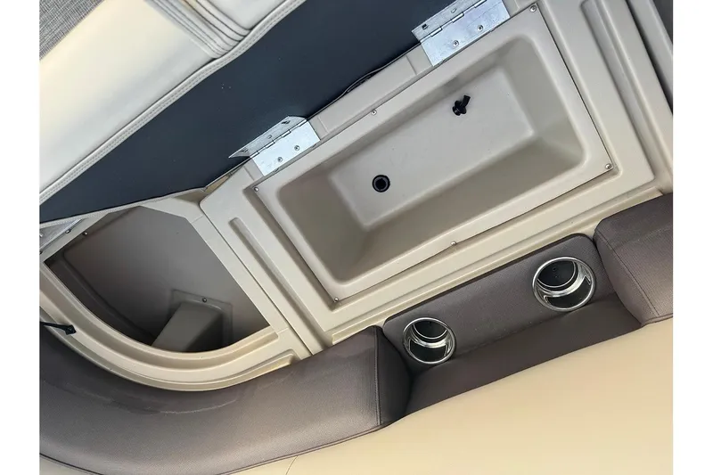 Slide: The Image of Interior view of 2026 Bentley Pontoons Legacy 223 Swingback, featuring storage compartment and cup holders. - 15