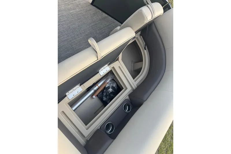 Slide: The Image of 2026 Bentley Pontoons Legacy 223 Swingback interior storage compartment with cup holders. - 18