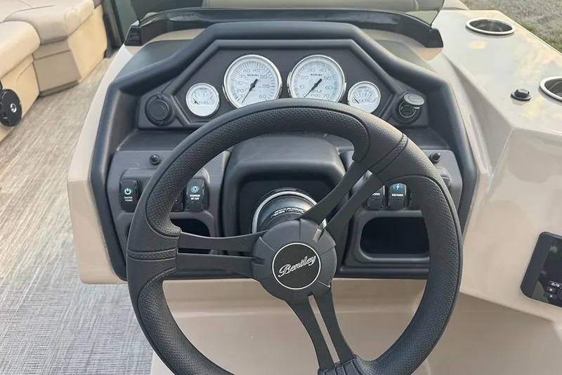 Slide: The Image of 2026 Bentley Pontoons Legacy 223 Swingback dashboard with steering wheel and gauges. - 24