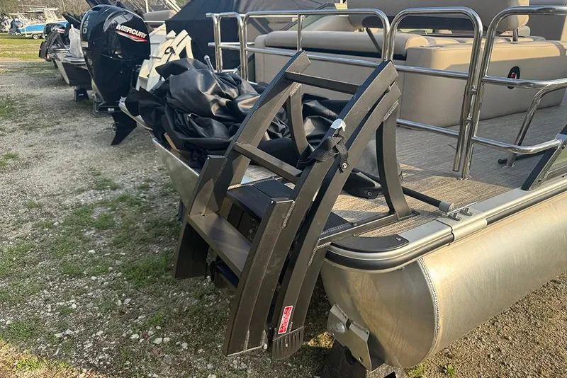 Slide: The Image of 2026 Bentley Pontoons Legacy 223 Swingback with Mercury outboard engine, docked on gravel. - 4