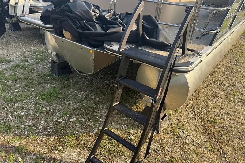 Slide: The Image of 2026 Bentley Pontoons Legacy 223 Swingback with ladder on gravel surface. - 5