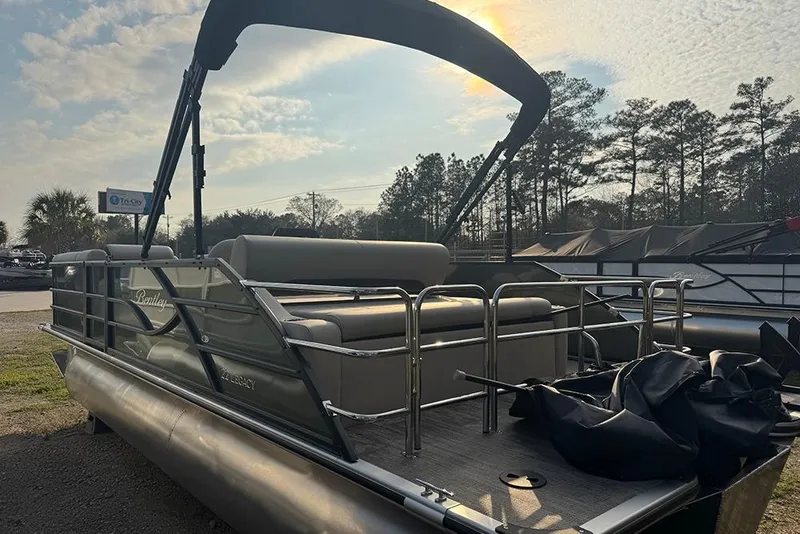 Slide: The Image of 2026 Bentley Pontoons Legacy 223 Swingback under a sunny sky, showcasing sleek design and comfort. - 7