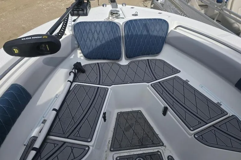 Slide: The Image of 2012 Sea Fox 226 Center Console boat interior with cushioned seating and storage compartments. - 10