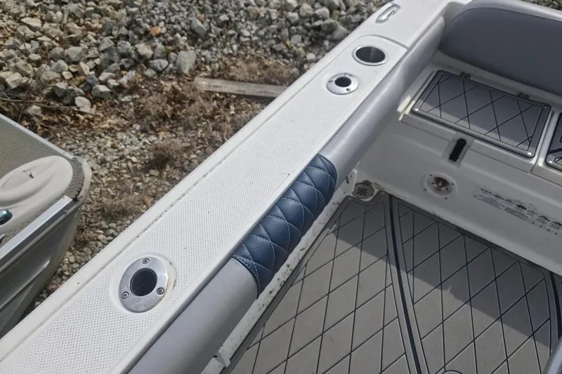 Slide: The Image of 2012 Sea Fox 226 Center Console boat interior with rod holders and cushioned seating. - 13