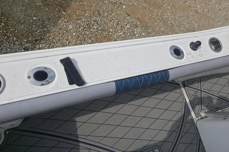 Slide: The Image of 2012 Sea Fox 226 Center Console boat interior with rod holders and cushioned rail. - 14