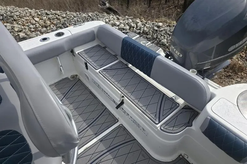 Slide: The Image of 2012 Sea Fox 226 Center Console boat interior with cushioned seating and storage compartments. - 5