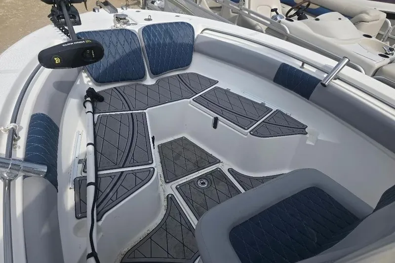 Slide: The Image of 2012 Sea Fox 226 Center Console boat interior with blue and gray seating and deck. - 9