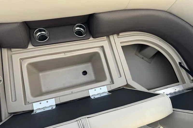 Slide: The Image of 2026 Bentley Pontoons Legacy 223 Swingback interior with cup holders and storage compartments. - 13