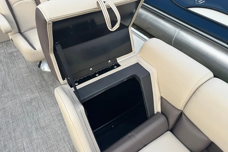 Slide: The Image of 2026 Bentley Pontoons Legacy 223 Swingback seat storage compartment open, showcasing interior space. - 14