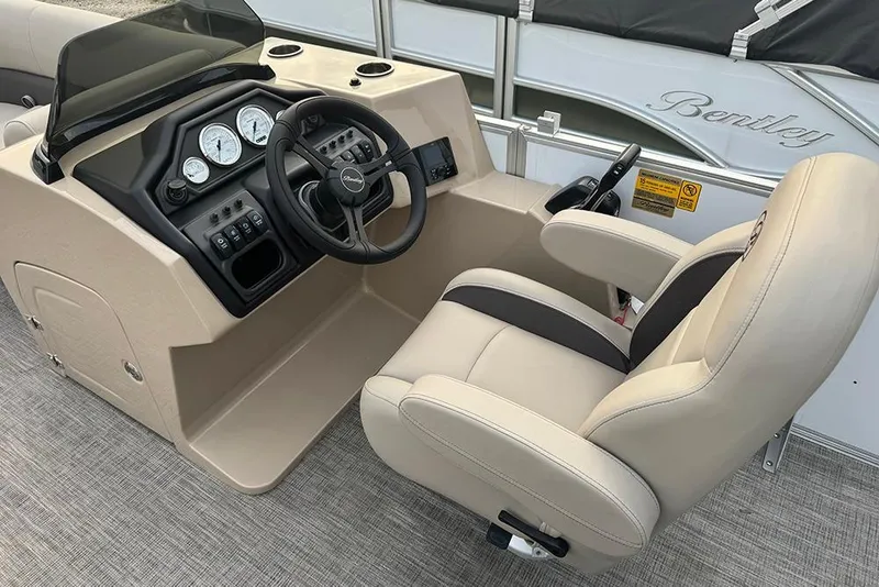 Slide: The Image of 2026 Bentley Pontoons Legacy 223 Swingback helm with beige captain's chair and control panel. - 19