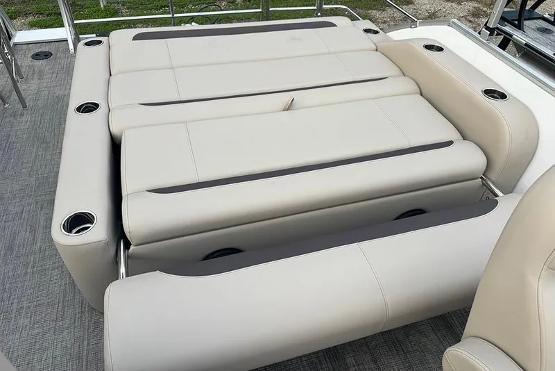 Slide: The Image of 2026 Bentley Pontoons Legacy 223 Swingback with luxurious beige seating and cup holders. - 22