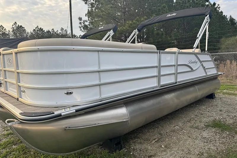 Slide: The Image of 2026 Bentley Pontoons Legacy 223 Swingback, sleek design, parked outdoors, overcast sky. - 3