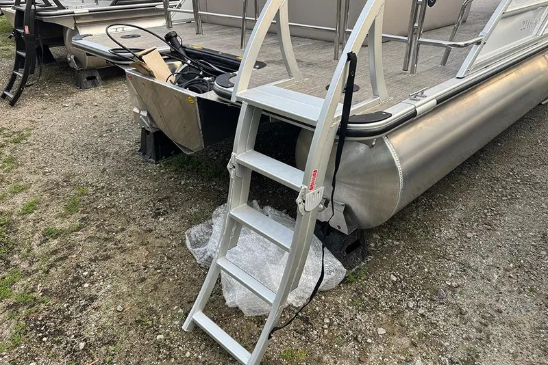 Slide: The Image of 2026 Bentley Pontoons Legacy 223 Swingback with ladder on gravel surface. - 8