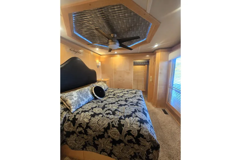 Slide: The Image of Luxurious bedroom in 2013 Thoroughbred 80'x 18' model with elegant decor and ceiling fan. - 34