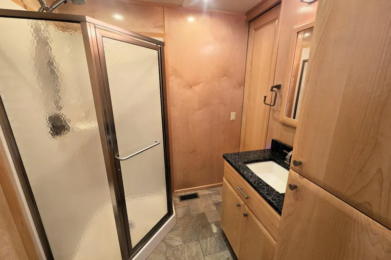 Slide: The Image of Modern bathroom in 2013 Thoroughbred model with shower and granite countertop. - 44