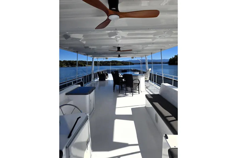 Slide: The Image of Luxurious 2013 Thoroughbred 80'x 18' houseboat with spacious deck and scenic lake view. - 7
