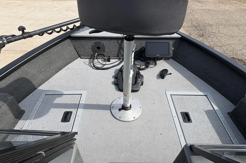 Slide: The Image of 2017 Starcraft Renegade 168 DC boat interior with seat, control panel, and storage compartments. - 10