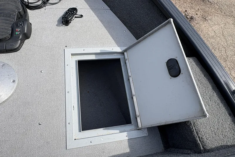 Slide: The Image of Open storage compartment on 2017 Starcraft Renegade 168 DC boat deck. - 11
