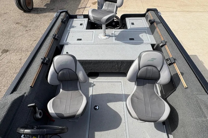 Slide: The Image of 2017 Starcraft Renegade 168 DC boat interior with three gray seats and storage compartments. - 13