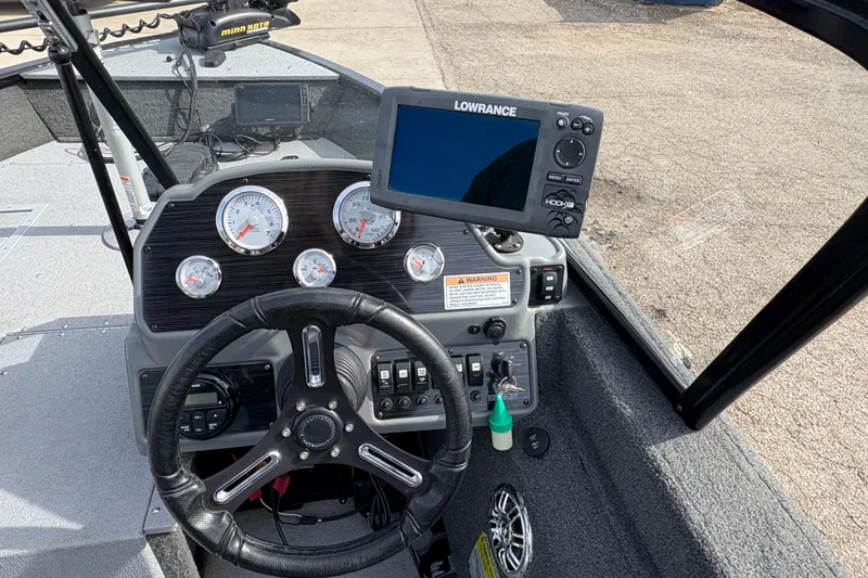 Slide: The Image of 2017 Starcraft Renegade 168 DC boat dashboard with steering wheel and Lowrance fishfinder. - 14