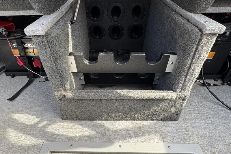 Slide: The Image of 2017 Starcraft Renegade 168 DC boat interior with rod holder and battery compartment. - 18