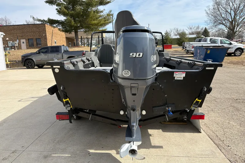 Slide: The Image of 2017 Starcraft Renegade 168 DC boat with Yamaha 90 outboard motor, parked outdoors. - 2