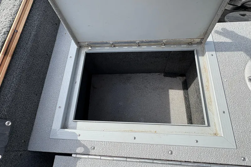 Slide: The Image of Open storage compartment on 2017 Starcraft Renegade 168 DC boat deck. - 21