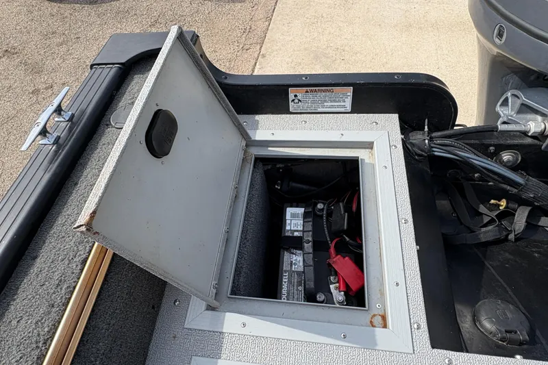 Slide: The Image of Open battery compartment on 2017 Starcraft Renegade 168 DC boat, showing wiring and connections. - 22